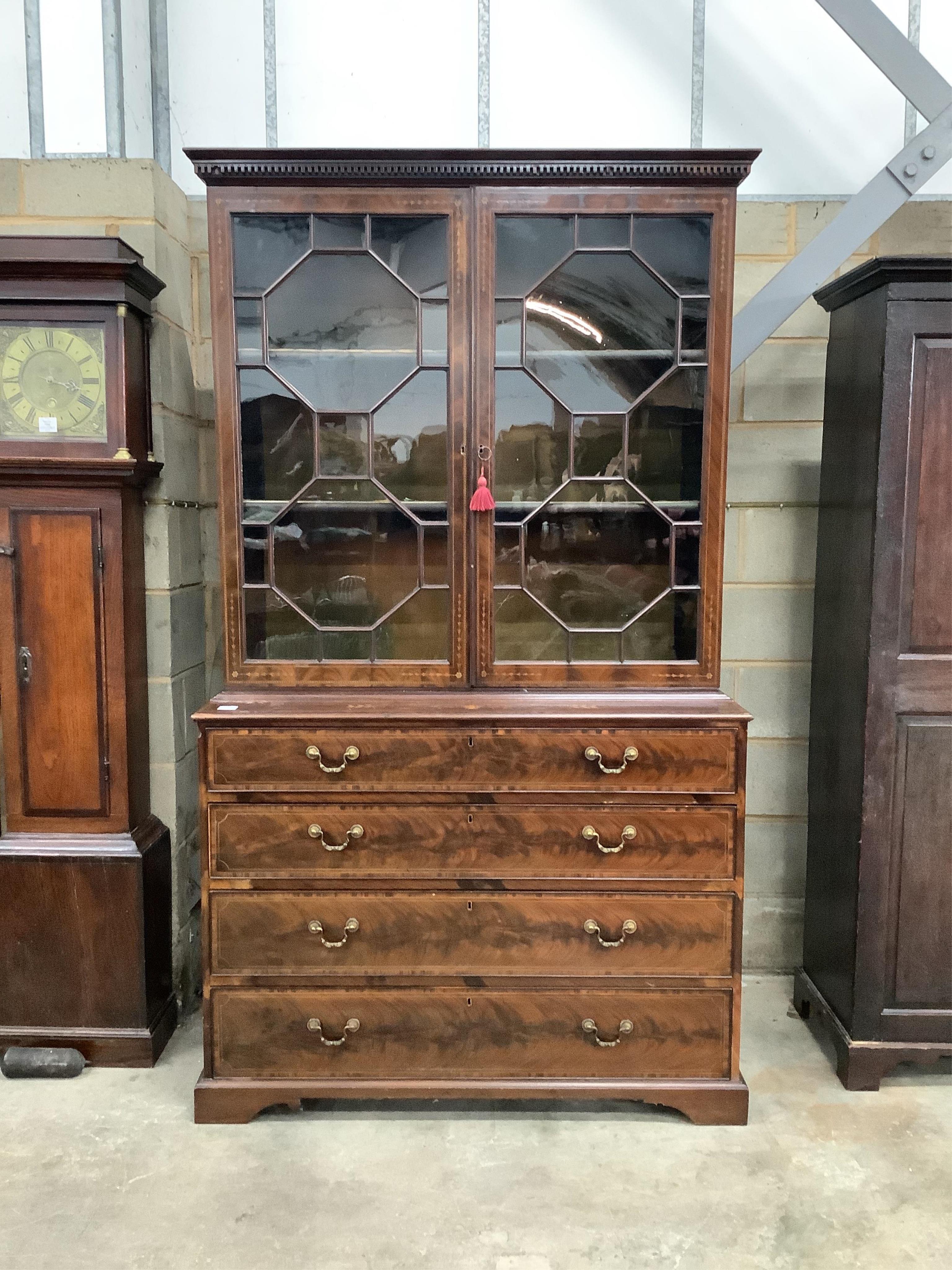 A late Victorian Sheraton Revival inlaid mahogany bookcase retailed by S & H Jewell, width 125cm, height 217cm. Condition - good